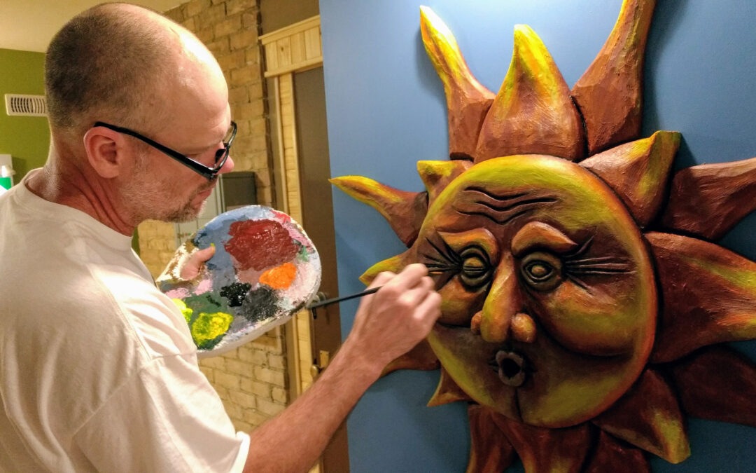 tony hale paints a large sun sculpture on the wall