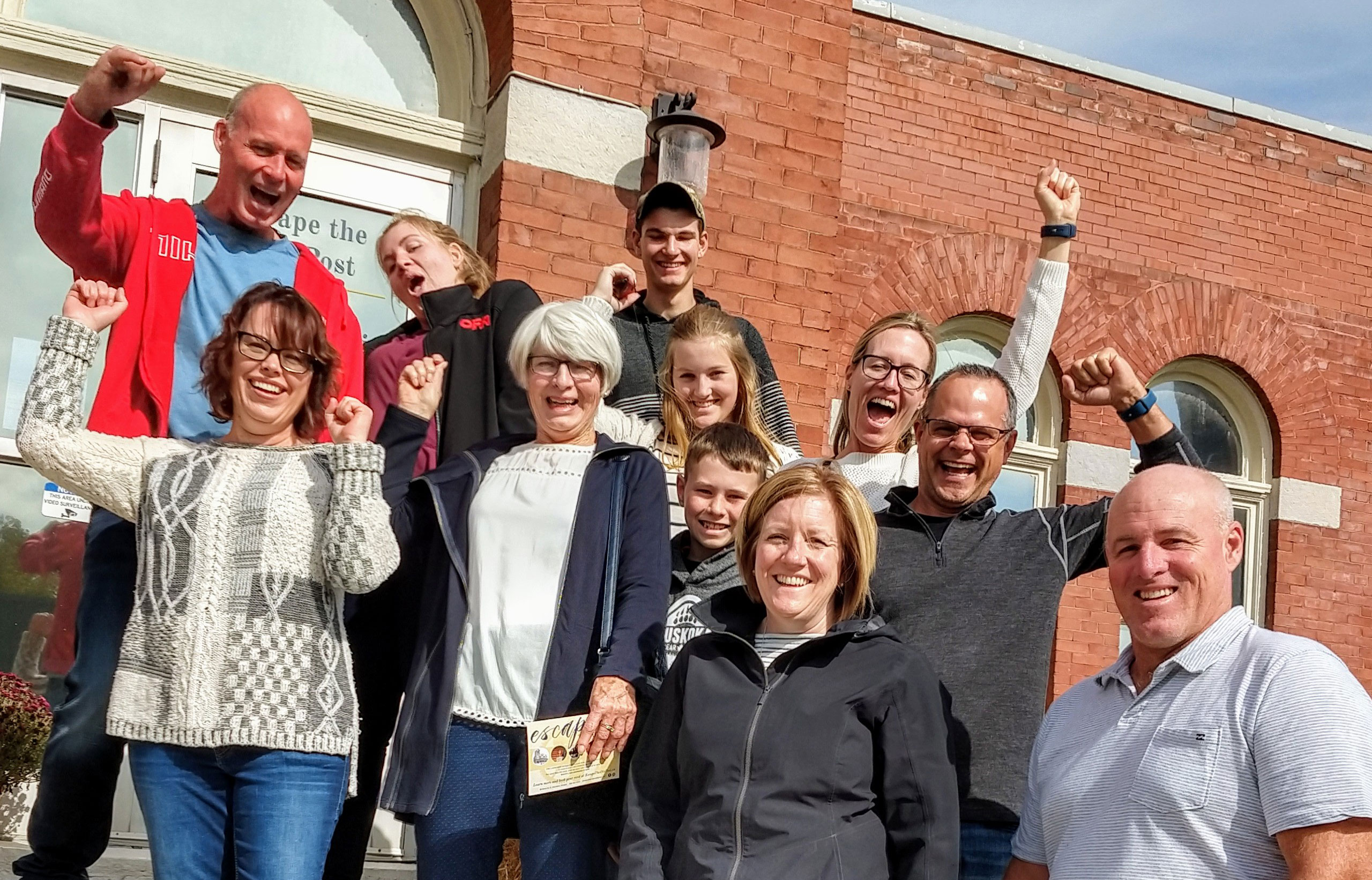 escape-room-the-old-post-game-harriston family group standing on steps of the old post in harriston